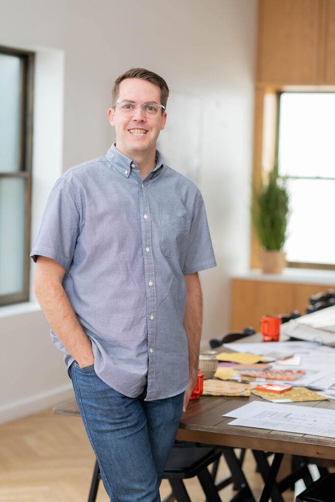 Architect standing in studio focused on custom interior design, architectural design, and master planning services