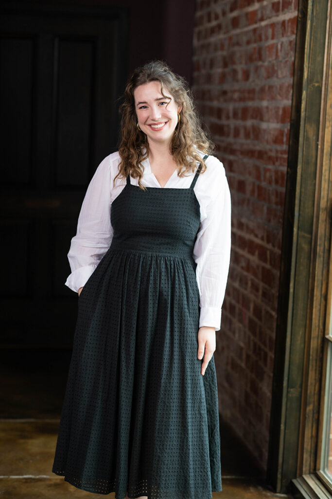 Team member standing in studio environment focused on custom interior design, architectural design, and master planning