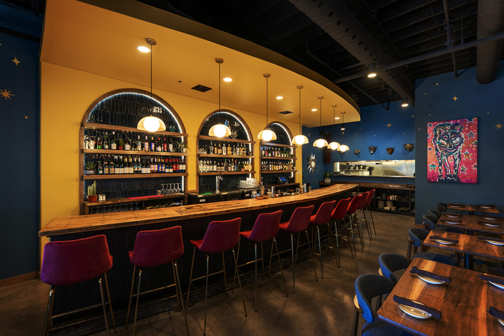 Bar seating and back bar design inside La Loba restaurant